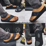 A pair of Prada slides worn by a man, showcasing the comfort and style of the luxury footwear