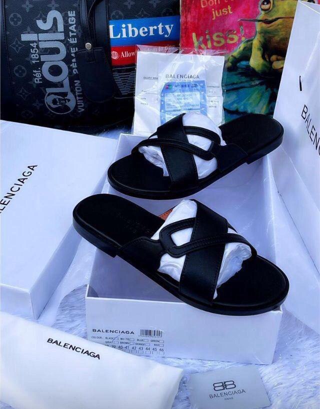 Pair of black leather Balenciaga sandals on a white background