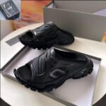 A pair of black BALENCIAGA sport sandals in a shoe box, perfect for comfortable and stylish footwear.