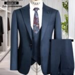 A navy blue three-piece suit with a floral tie on a mannequin, perfect for formal occasions.
