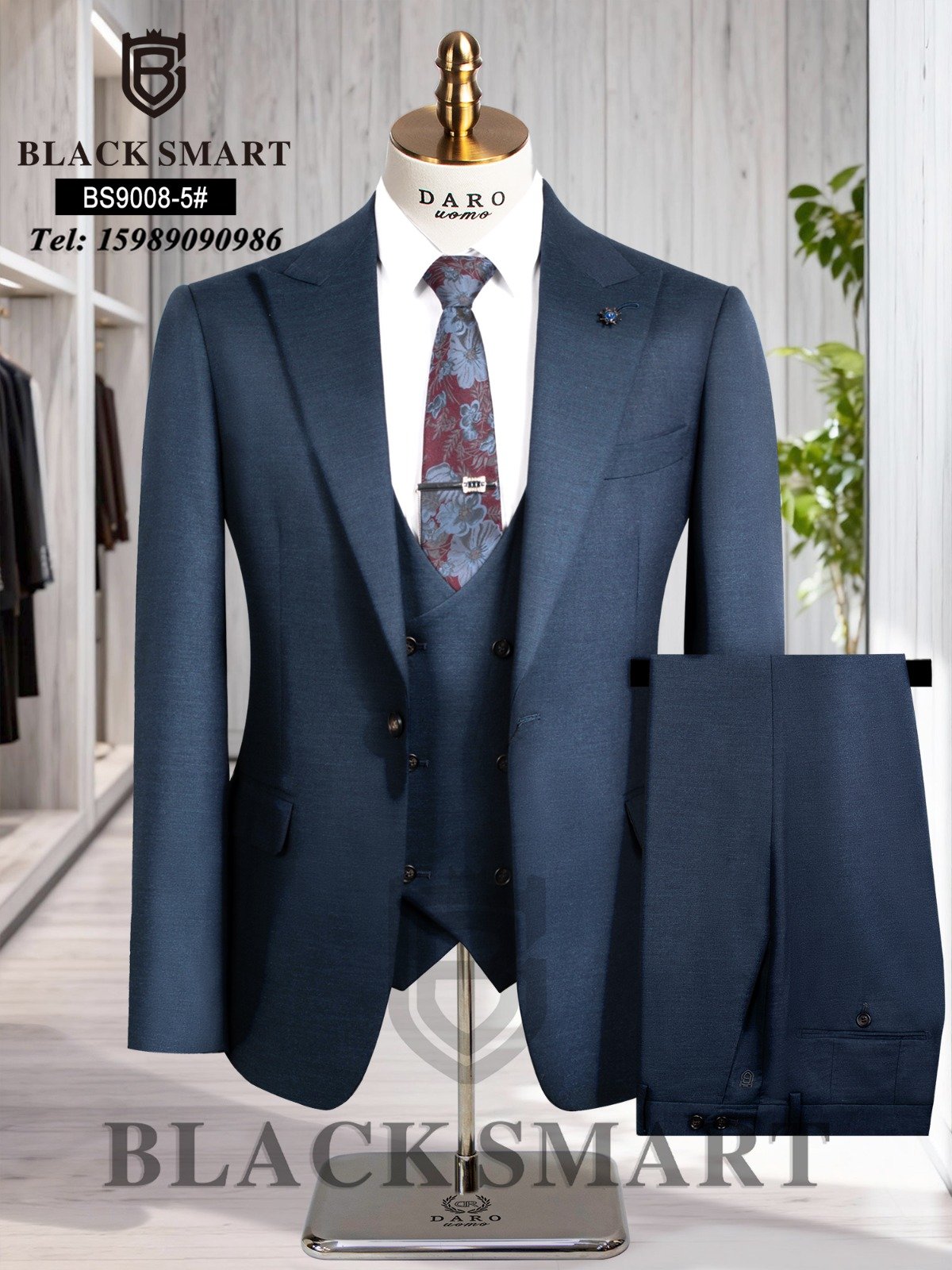 A navy blue three-piece suit with a floral tie on a mannequin, perfect for formal occasions.