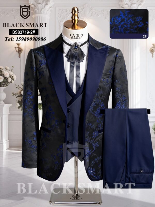 A navy blue suit with floral pattern, including jacket, vest, and trousers, displayed on a mannequin.