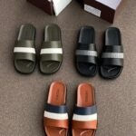 A collection of Pedro brand colorful two-strap rubber sandals for men and women, displayed with shoe boxes on a brown surface.