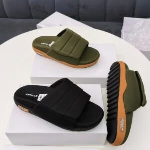 A display of black and olive green men's slipper sandals with double-striped design on a white table, showcasing comfort and style for casual wear.