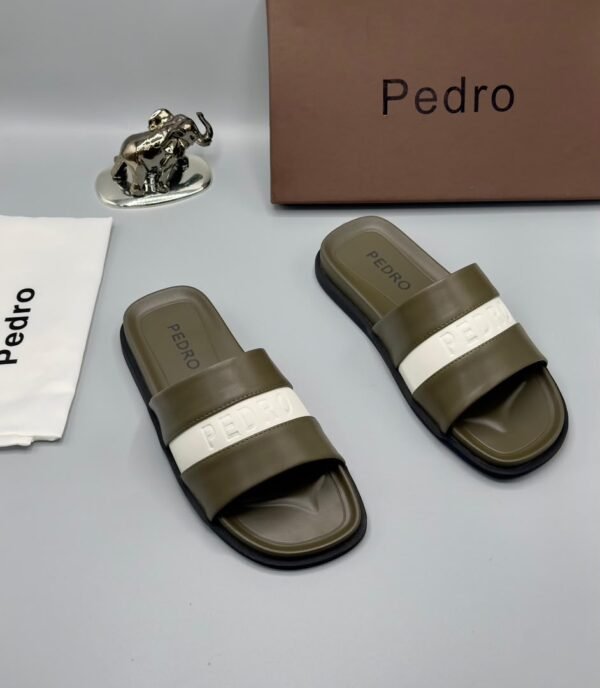 A pair of stylish brown slides with navy blue and white stripes, accompanied by a brown shoe box and accessories, all bearing the 'Pedro' brand name.