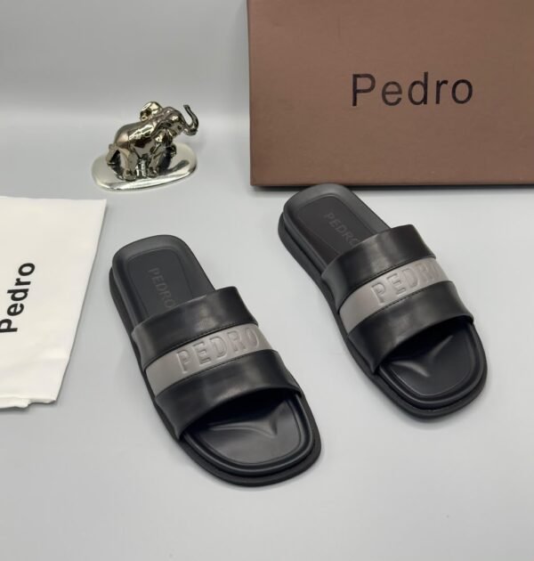A pair of stylish brown slides with navy blue and white stripes, accompanied by a brown shoe box and accessories, all bearing the 'Pedro' brand name.